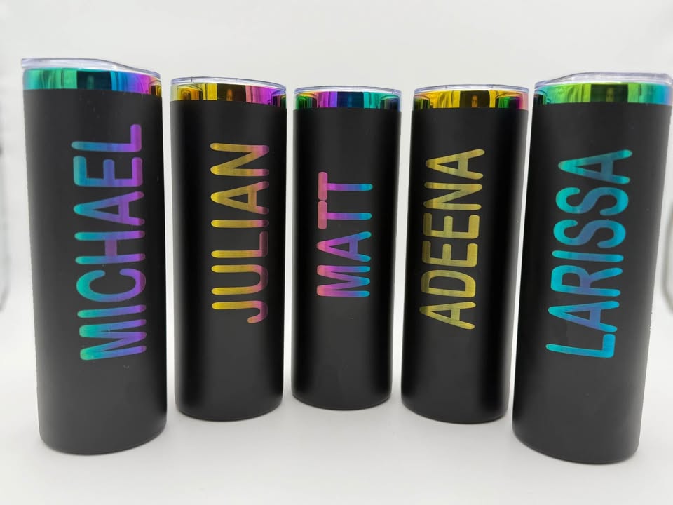 Five black tumblers engraved with colorful personalized names